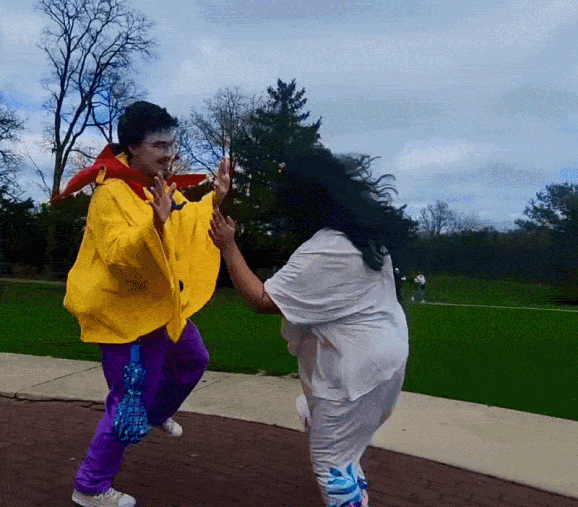 two clowns mirroring each other's whimsical dance